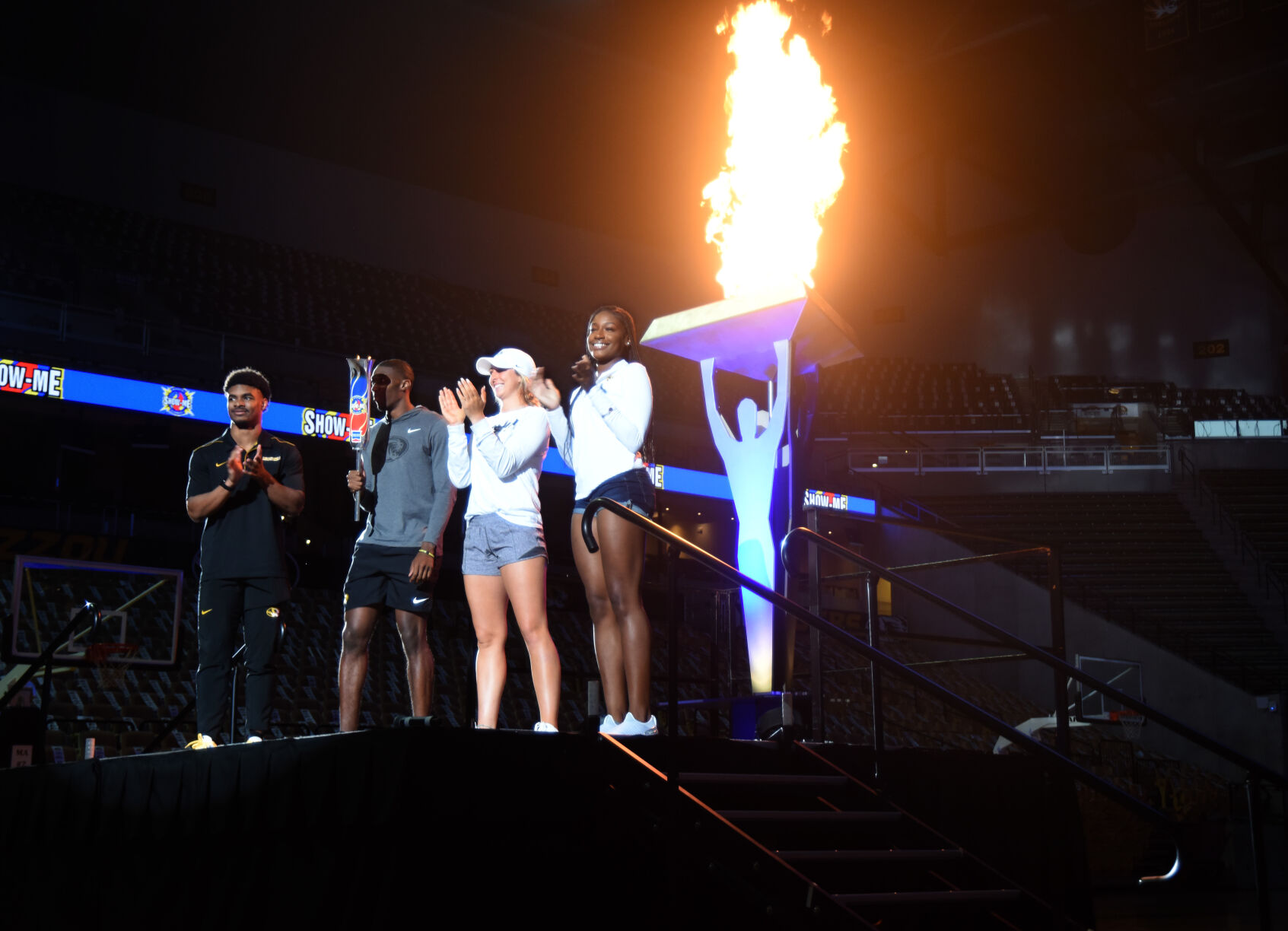 Missouri athletes Chris Shearin, Jalani Williams, Cayla Kessinger and Euphenie Andre light the